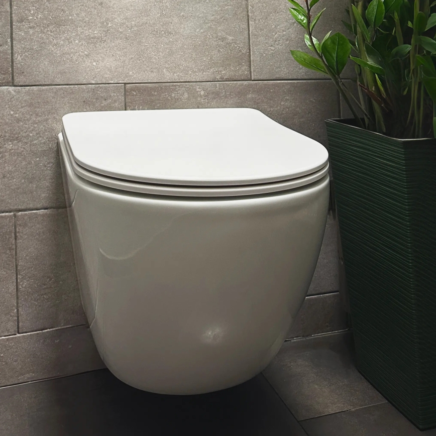 REA-C1259 - Závěsné WC s prkénkem CARLO MINI TORNADO RIMLESS keramika/lesklá bílá